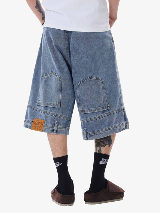 Person wearing blue denim shorts on a white background