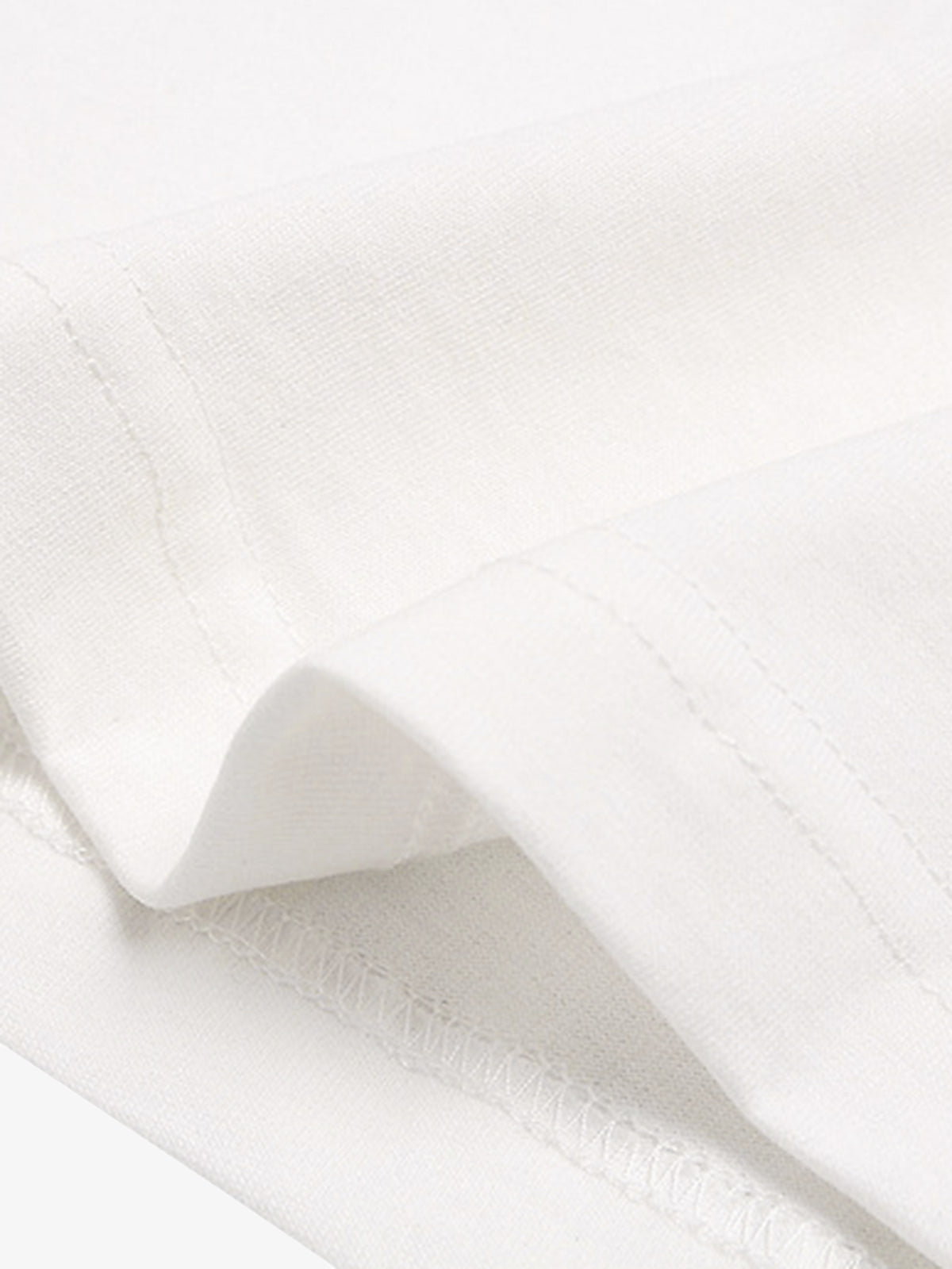 Close-up of white fabric with a subtle texture on a white background