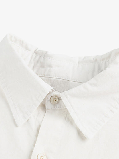 Stylish White Button-Up Shirt with Unique Patch Design for Casual and Trendy Looks?