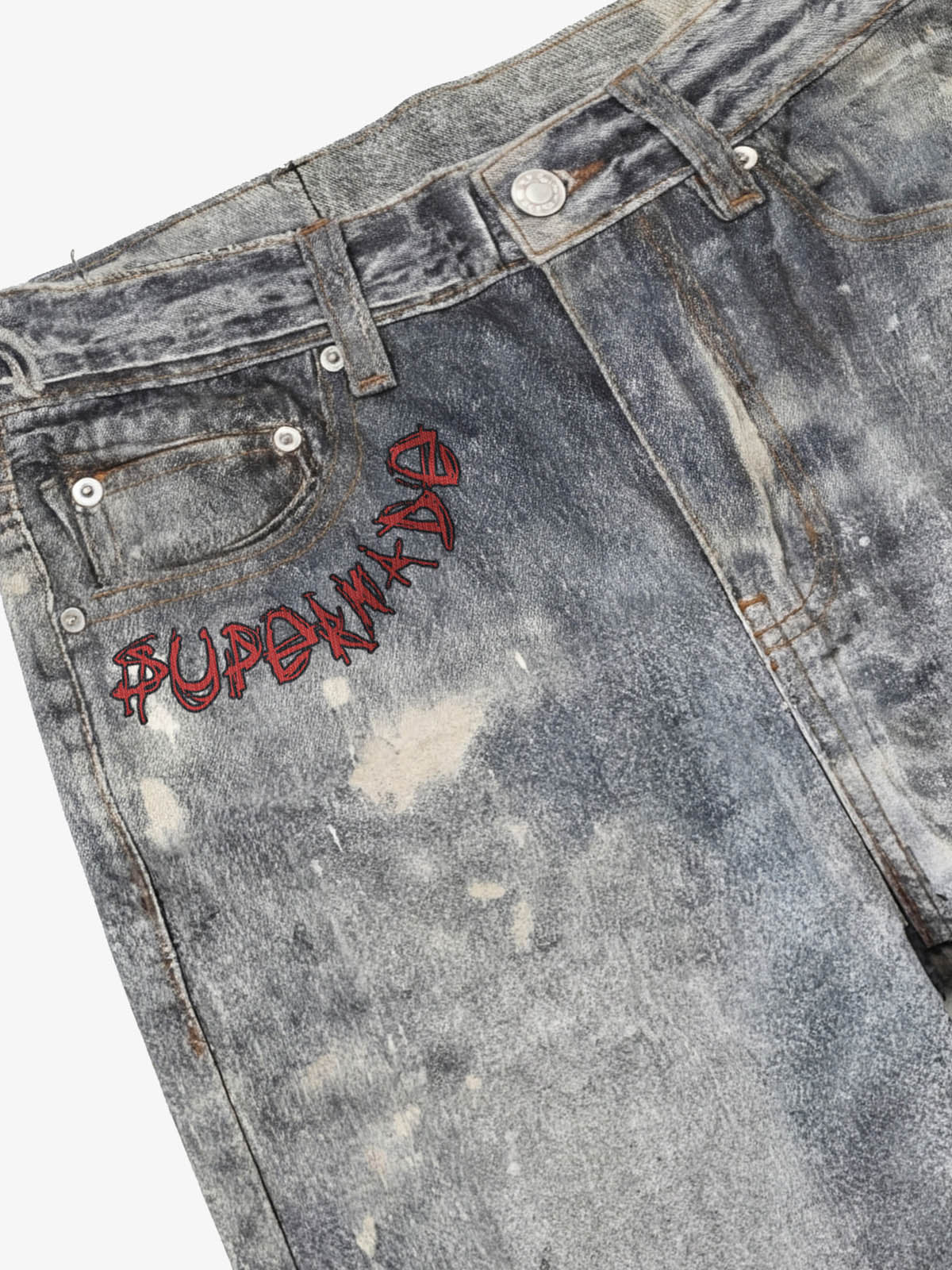 Distressed heavy-duty painted straight-leg jeans, adorned with red graffiti prints and paint-splatter wash effects?