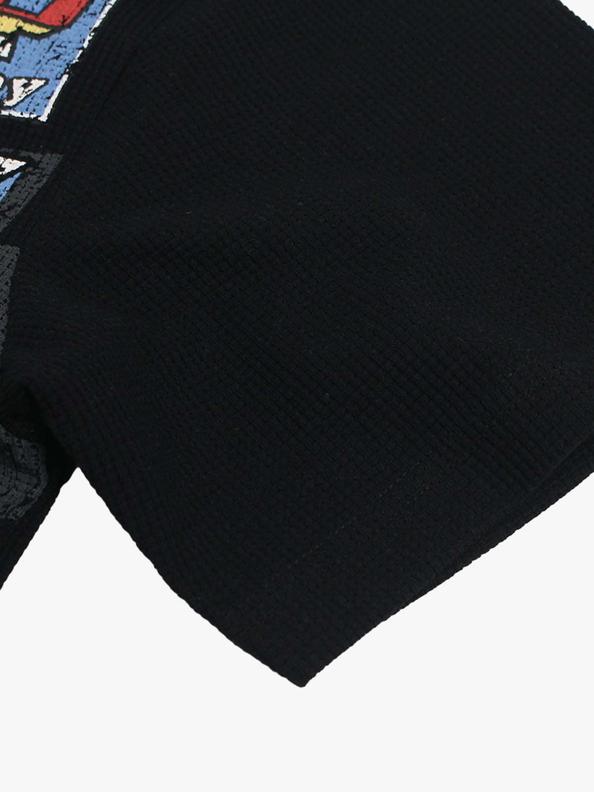 Cotton Oversized Graphic T-Shirt with Newspaper Print and Metal Eyelets?