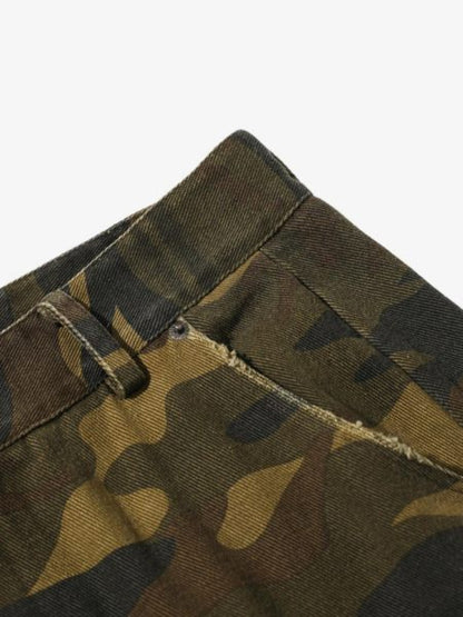 Close-up of camouflage fabric with a visible stitching detail on a white background