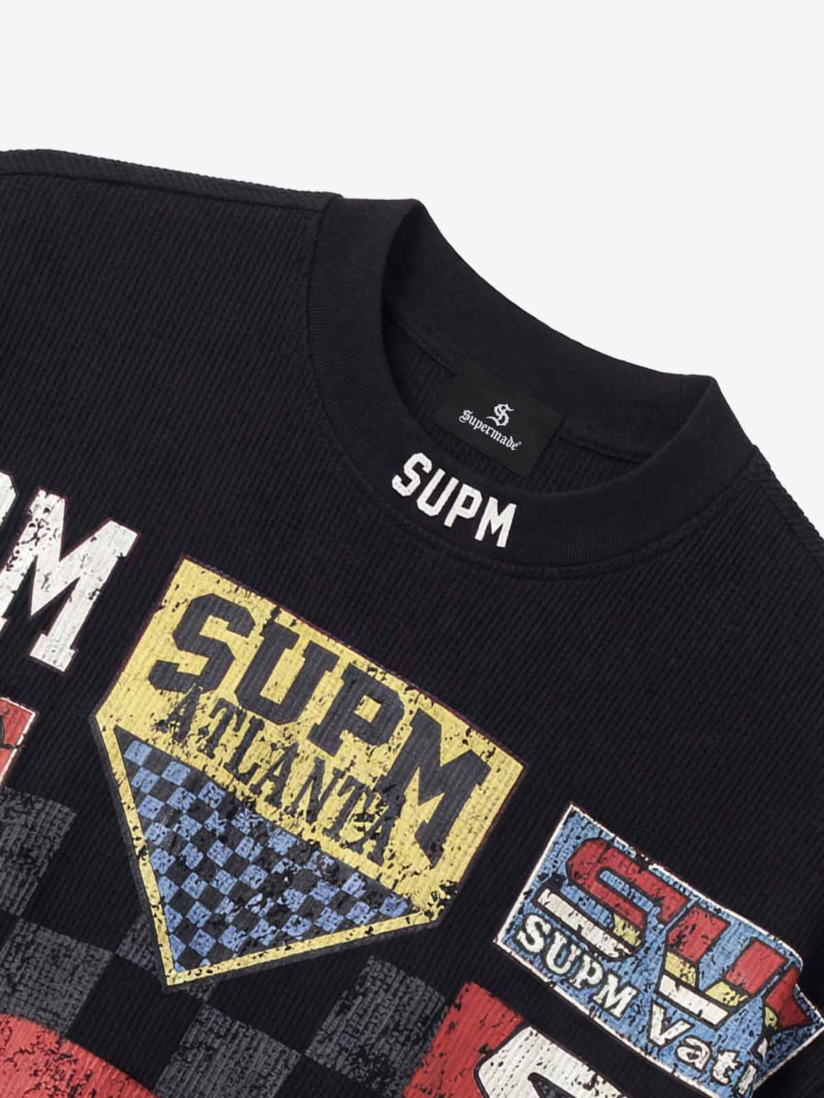 Cotton Oversized Graphic T-Shirt with Newspaper Print and Metal Eyelets?